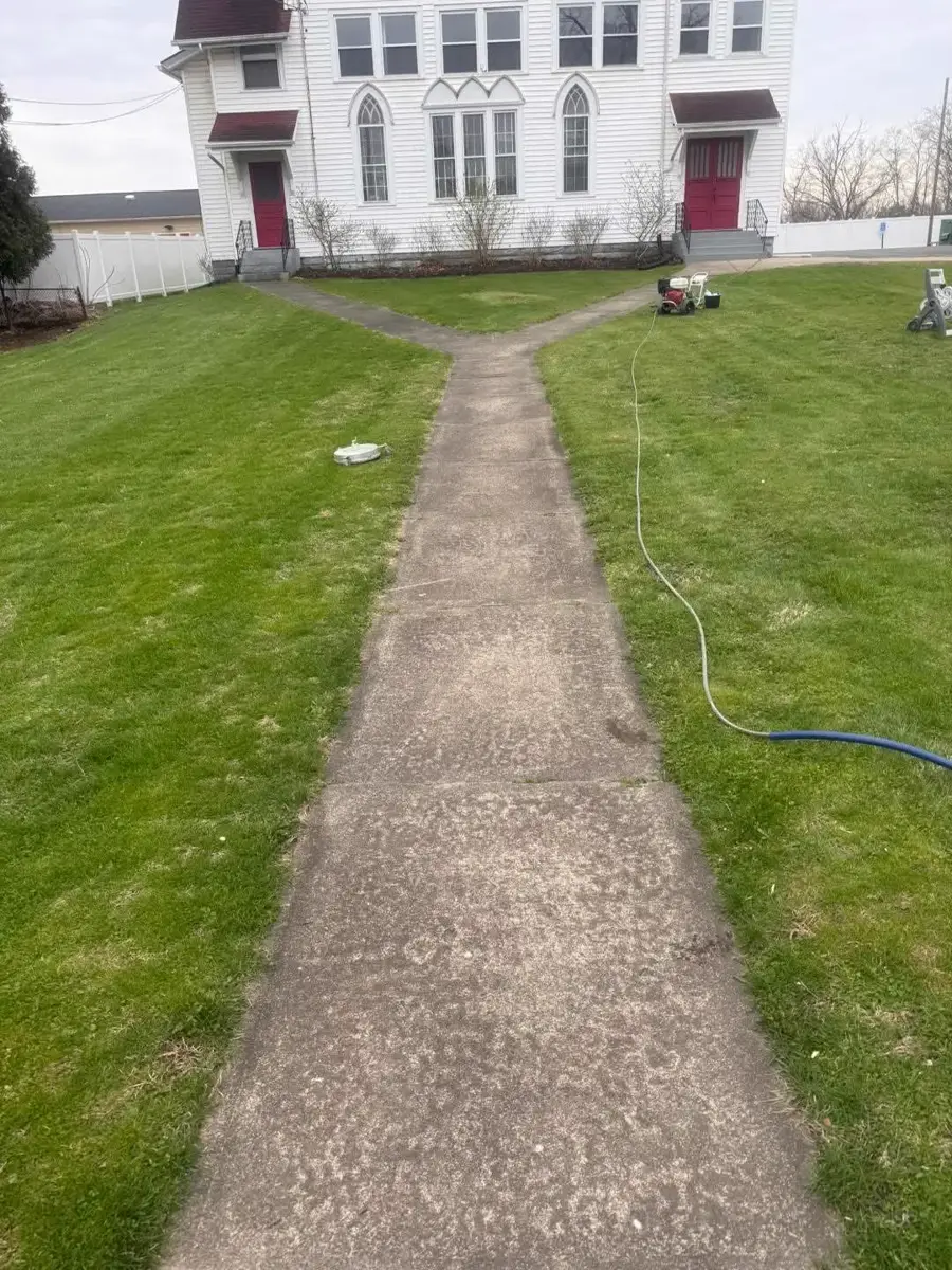 Walkway before pressure washing — stained concrete